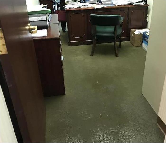 water on the carpet of an office