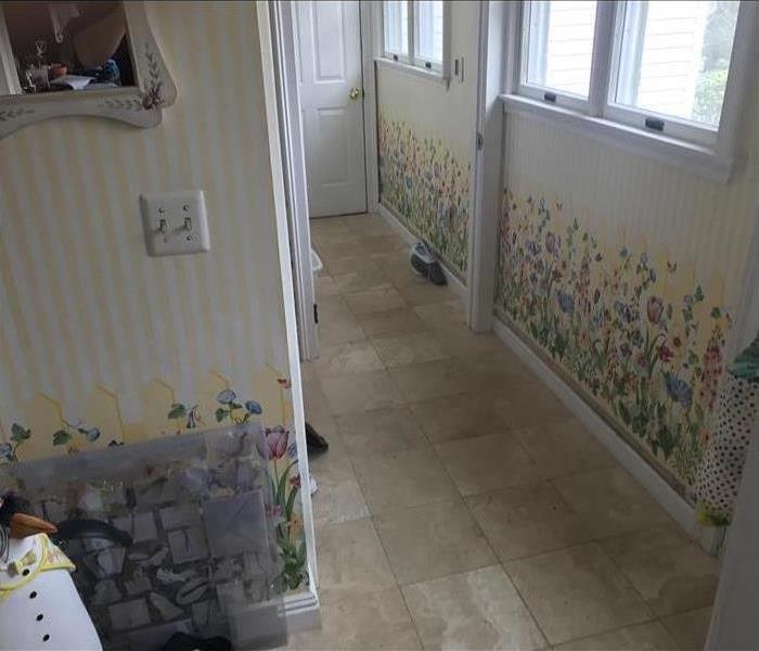 A hallway with brightly colored wallpaper. 